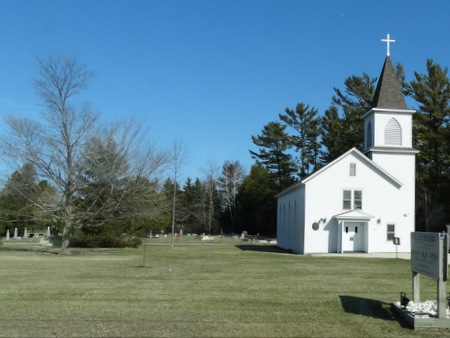 A church with a cemetery behind it
