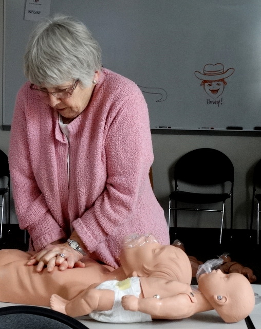 Judy giving CPR to a manikin. 