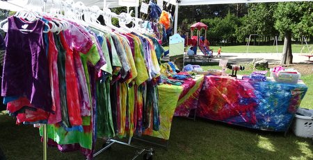 I talked with this vendor about the brilliance of the colors in her clothing.  She said it's not tie-dye but ice-dye.  You scrunch up whatever you want to dye in a bucket, fill the bucket with ice, and put powdered dye on top of the ice.  As the ice melts the color saturates the fabric.  It was beautiful!