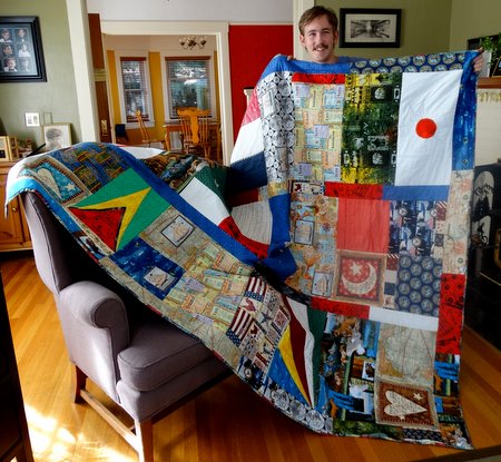 I had made a dorm quilt for Nate and delivered it in person.  It has many things that interest him on it.