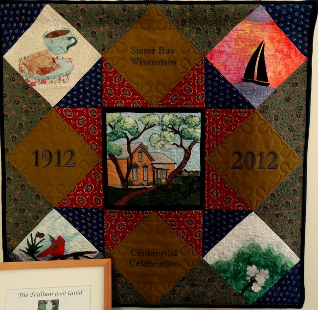 This was a centennial wall  quilt with a picture of the Old Anderson House Museum in the center.