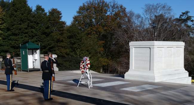 The two guards stood at attention while the sergeant saluted the tomb.