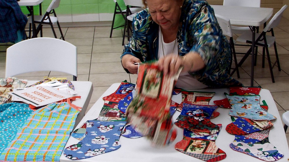 Kathy laying out the Christmas stockings for the military.  One of the women takes them to her church where they fill them with things servicemen and women might want, like playing cards or toiletries or such.
