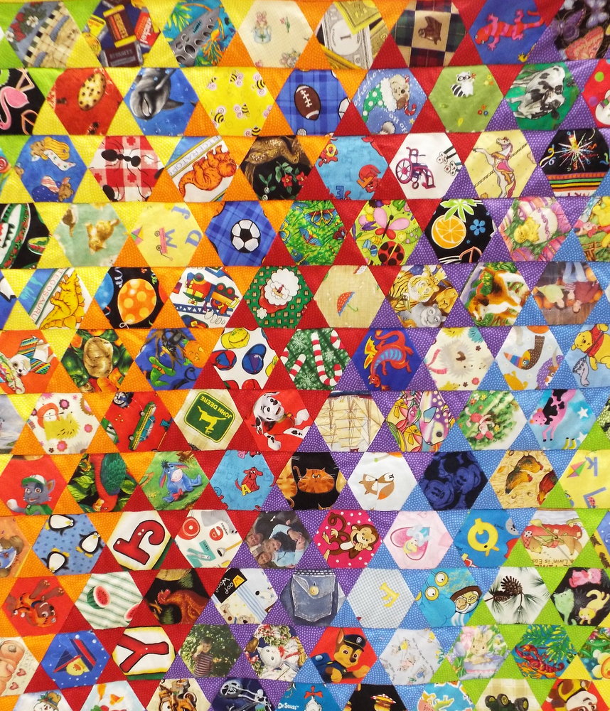 Judy made this "I spy" quilt for her grandson.  It's a game.  She can say, "I spy with my little eye a soccer ball, and her grandson will look for it on the quilt.