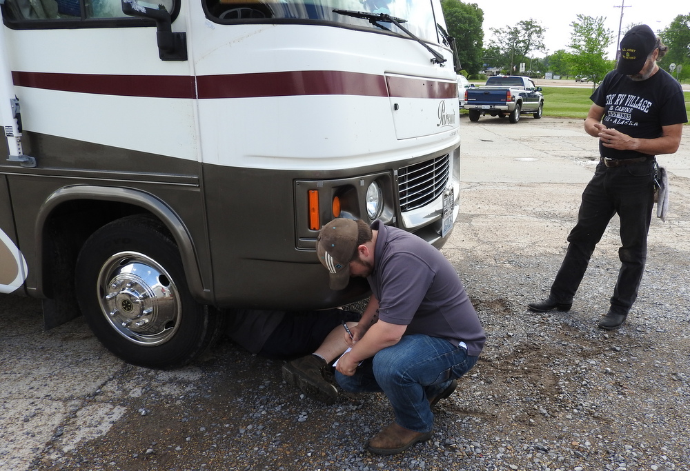 The guy under the RV was wearing a hat that said "Ephesians 6:7".  Mark asked me to read that to him: "Serve wholeheartedly, as if you were serving the Lord, not men..."  Mark said, "Yeah, we're going to have these guys fix the RV!"