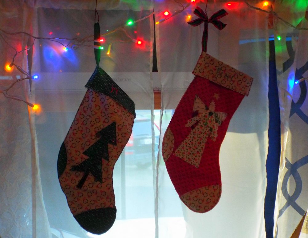 Our empty stockings hanging back up on our curtain rod