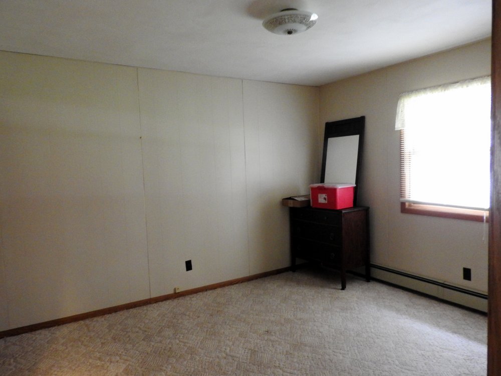 This will be our bedroom. The previous owner left a small dresser and mirror for us. We tried to set our bed up in the room and discovered we're missing part of the metal frame. 