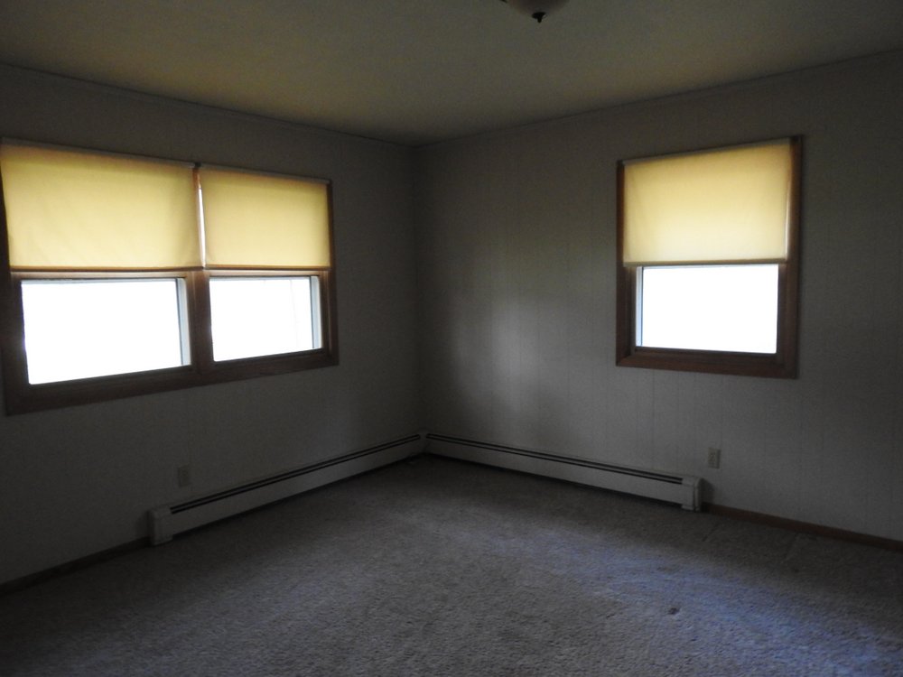 This is the larger of the two bedrooms and it's on the corner so it gets more light. We're going to use it for a guest room and my sewing room.