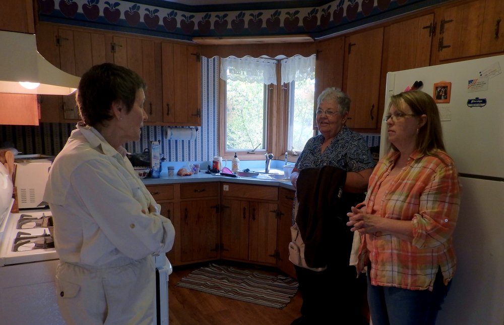 The woman on the left is Benay whom we met at Wagon Trail a couple summers ago. The woman closer to the window is Rosanne Curran and the one in front of the refrigerator is Kathy Plahmer, the friend who helped me clean yesterday. Both are quilters and both work at Wagon Trail.