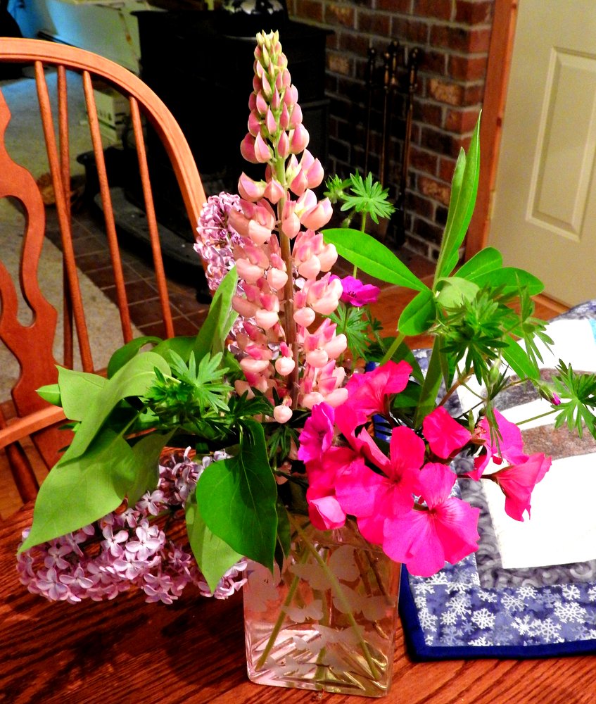 Lupine, lilacs, geraniums, and some small flower I'm not familiar with.